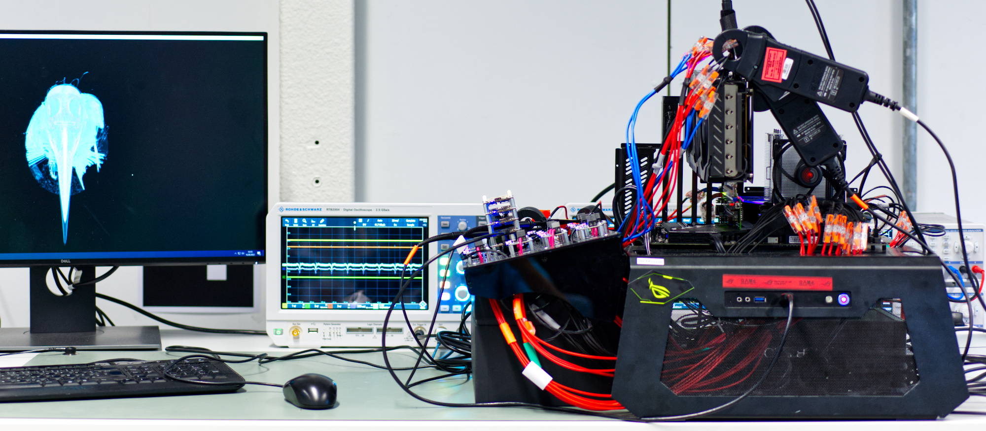 The test bench used in our power measurement experiments: All significant power rails of the system are redirected through microcontroller sensors. Additionally, an external power analyzer and oscilloscopes can be used for additional measurements and verification.